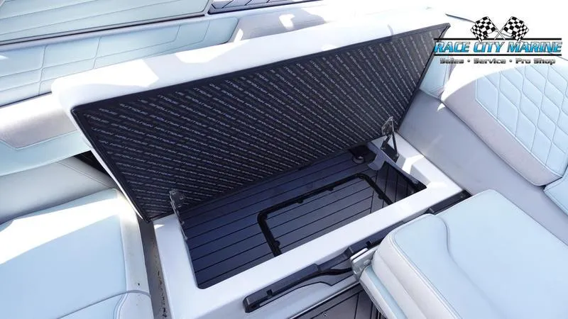 Slide: The Image of 2021 Nautique Super Air Nautique G23 interior storage compartment open, showcasing sleek design. - 24