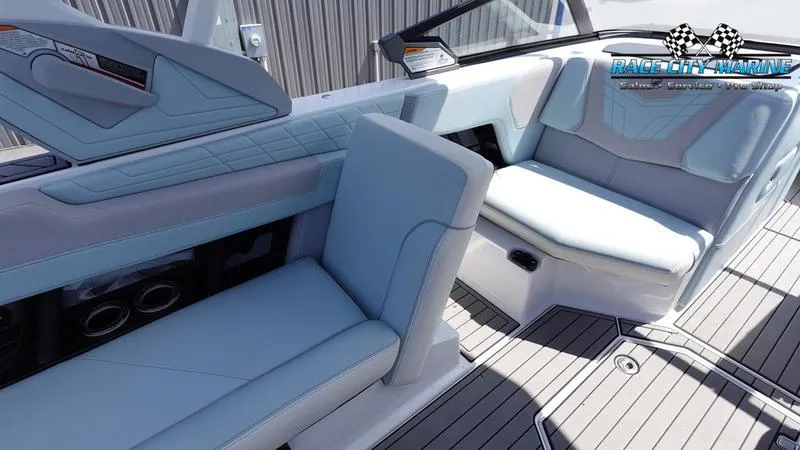 Slide: The Image of 2021 Nautique Super Air Nautique G23 interior with light blue seating and modern design. - 26