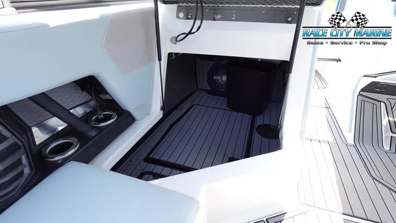 Slide: The Image of Interior of 2021 Nautique Super Air Nautique G23 boat with sleek seating and storage. - 30