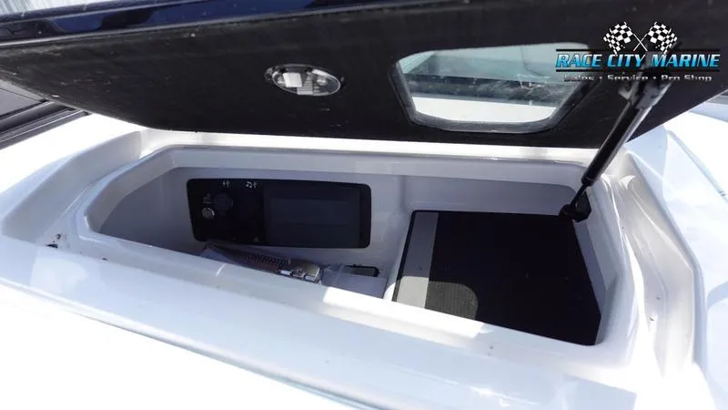 Slide: The Image of 2021 Nautique Super Air Nautique G23 storage compartment with open lid. - 31