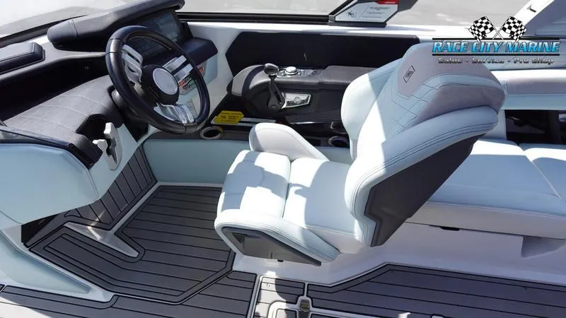 Slide: The Image of 2021 Nautique Super Air Nautique G23 boat interior with sleek steering and modern seating. - 32