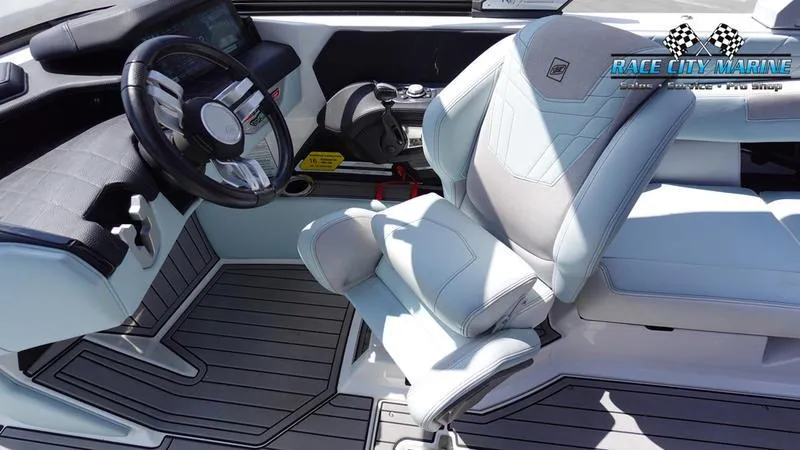 Slide: The Image of 2021 Nautique Super Air Nautique G23 boat interior with sleek steering and seating. - 33