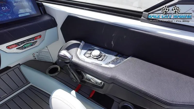 Slide: The Image of 2021 Nautique Super Air Nautique G23 boat interior with control panel and seating. - 34