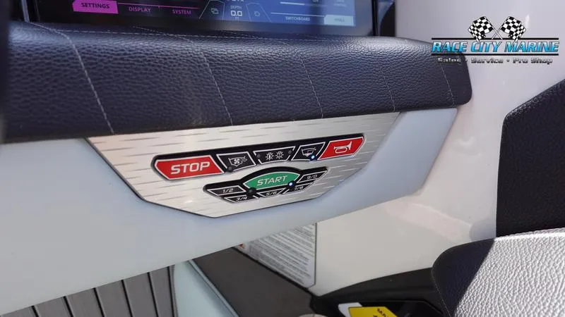 Slide: The Image of Control panel of 2021 Nautique Super Air Nautique G23 boat with start and stop buttons. - 40