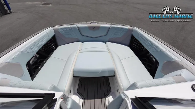 Slide: The Image of 2021 Nautique Super Air Nautique G23 boat interior with plush seating and Race City Marine logo. - 42