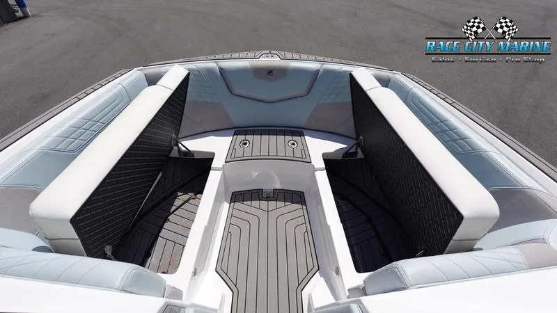 Slide: The Image of 2021 Nautique Super Air Nautique G23 boat interior with cushioned seating and sleek design. - 44