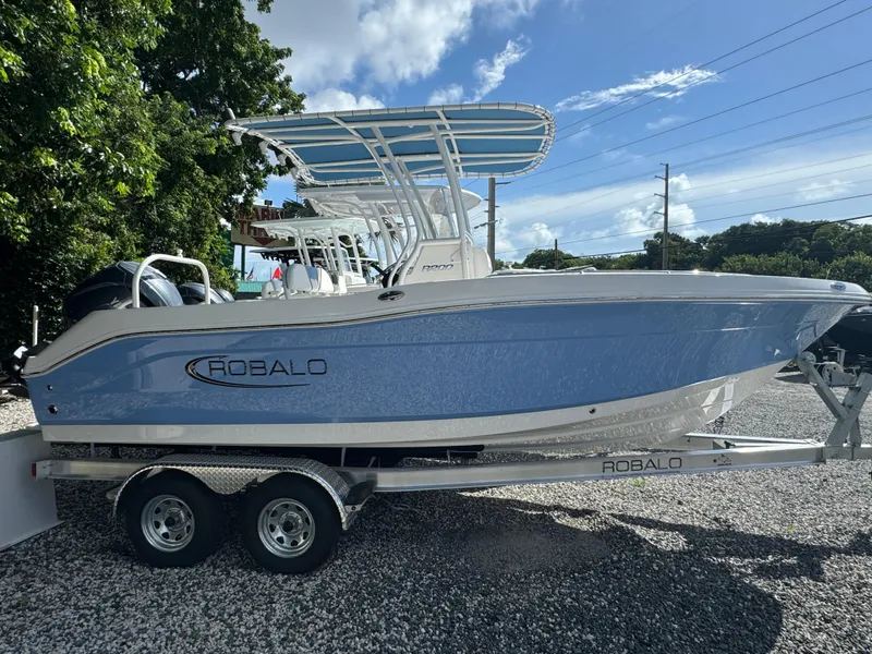 Slide: The Image of 2025 Robalo R200 Center Console boat on trailer, parked outdoors. - 1