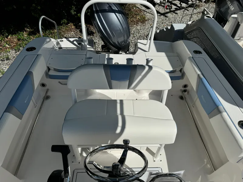 Slide: The Image of 2025 Robalo R200 Center Console boat interior with steering wheel and seating. - 13