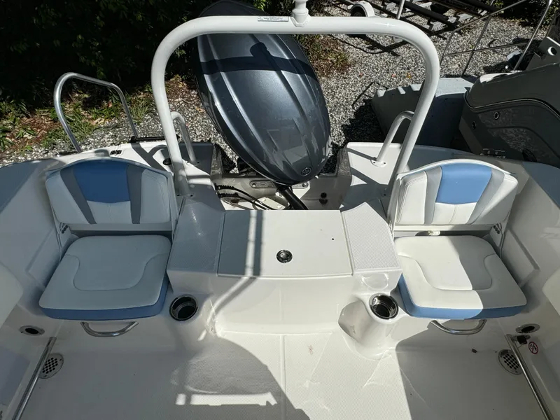Slide: The Image of 2025 Robalo R200 Center Console boat interior with seating and engine view. - 18