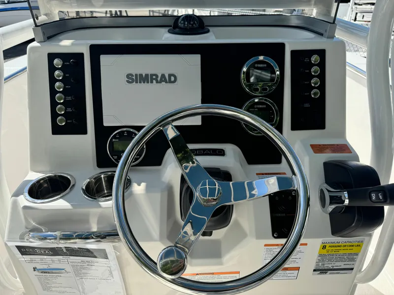 Slide: The Image of 2025 Robalo R200 Center Console dashboard with Simrad display and steering wheel. - 20
