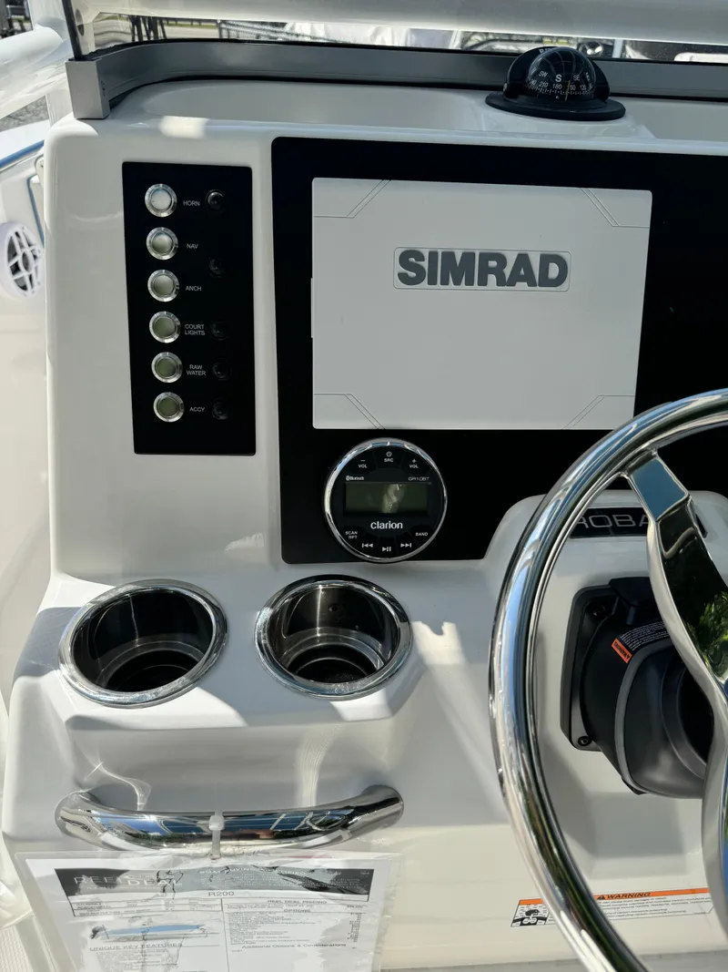 Slide: The Image of 2025 Robalo R200 Center Console dashboard with Simrad display and controls. - 22