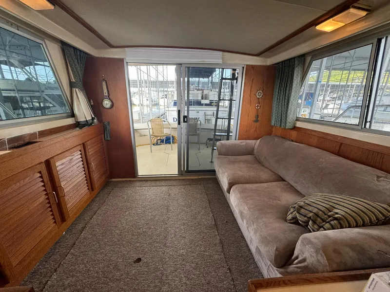 Slide: The Image of Interior of 1986 Silverton 34 Convertible yacht with sofa, carpet, and sliding glass doors. - 11