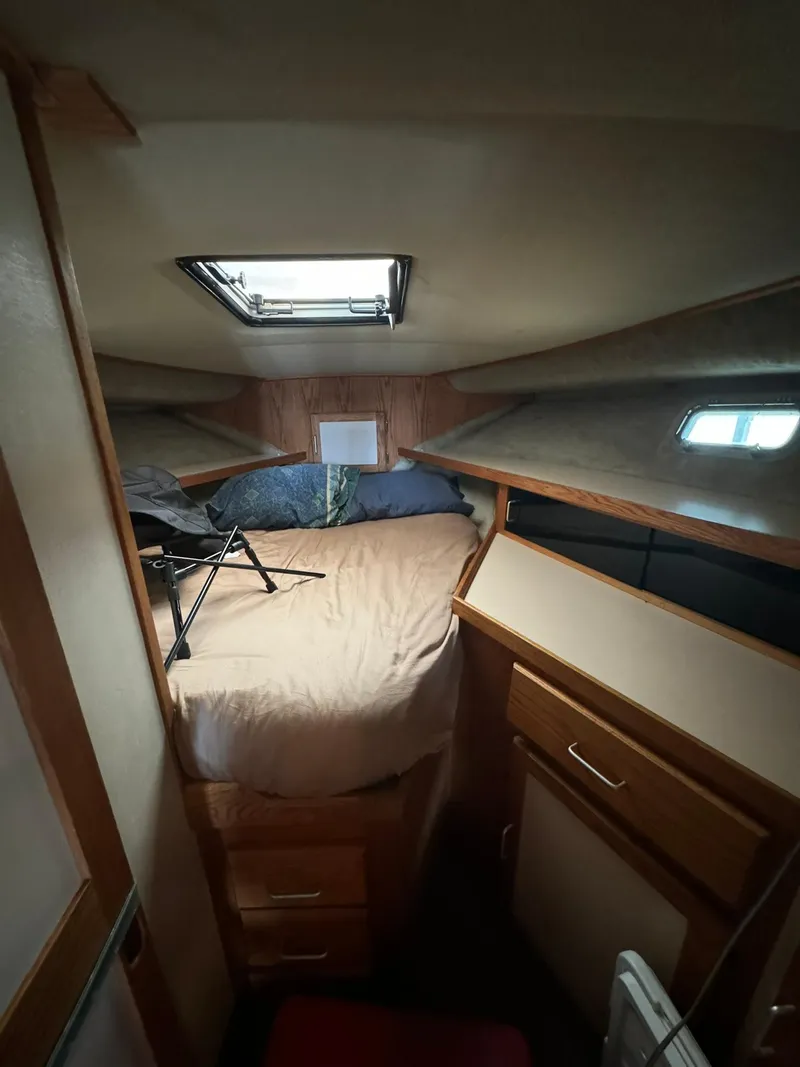 Slide: The Image of 1986 Silverton 34 Convertible cabin interior with bed, skylight, and storage drawers. - 14