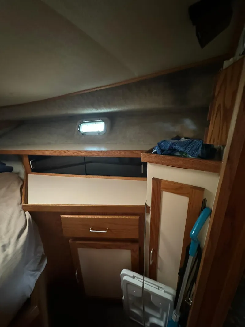 Slide: The Image of 1986 Silverton 34 Convertible cabin interior with wooden cabinetry and small window. - 15