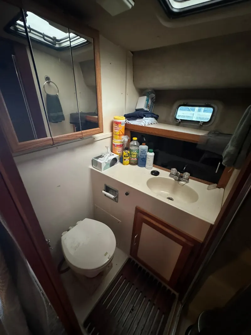 Slide: The Image of Bathroom interior of 1986 Silverton 34 Convertible boat with sink and toilet. - 16