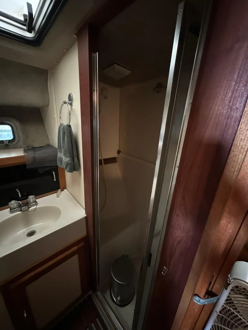 Slide: The Image of 1986 Silverton 34 Convertible bathroom with sink, shower, and towel rack. - 17