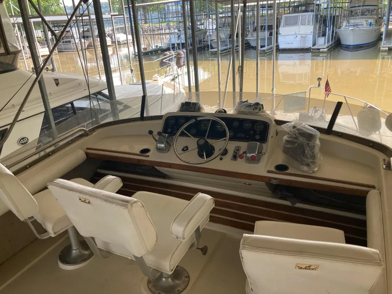 Slide: The Image of 1986 Silverton 34 Convertible boat interior with helm and seating in marina. - 20