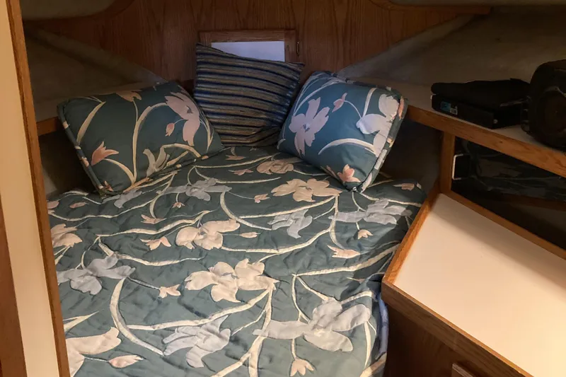 Slide: The Image of Cozy cabin interior of 1986 Silverton 34 Convertible with floral bedding and pillows. - 22