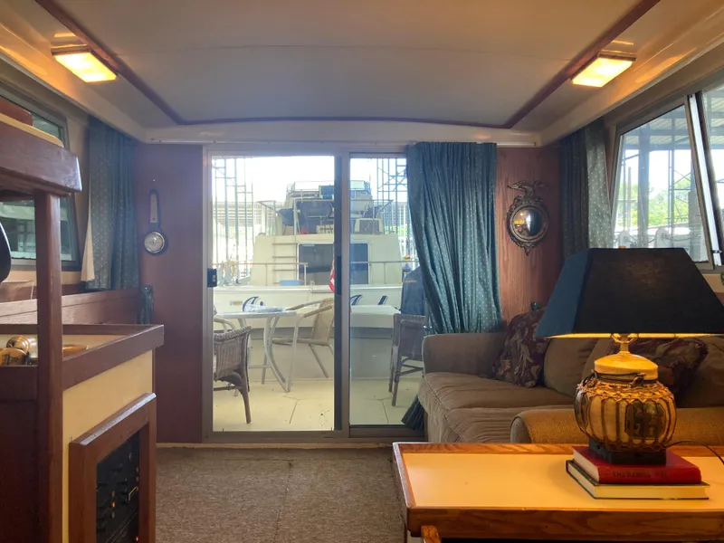 Slide: The Image of Interior of 1986 Silverton 34 Convertible yacht with cozy seating and nautical decor. - 23