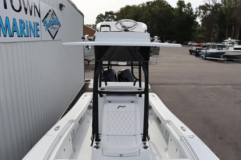 Slide: The Image of 2025 Yellowfin 26 Hybrid boat at a marina, showcasing sleek design and modern features. - 10
