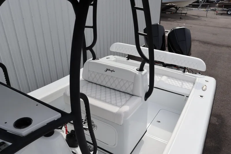 Slide: The Image of 2025 Yellowfin 26 Hybrid boat interior with seating and console. - 11