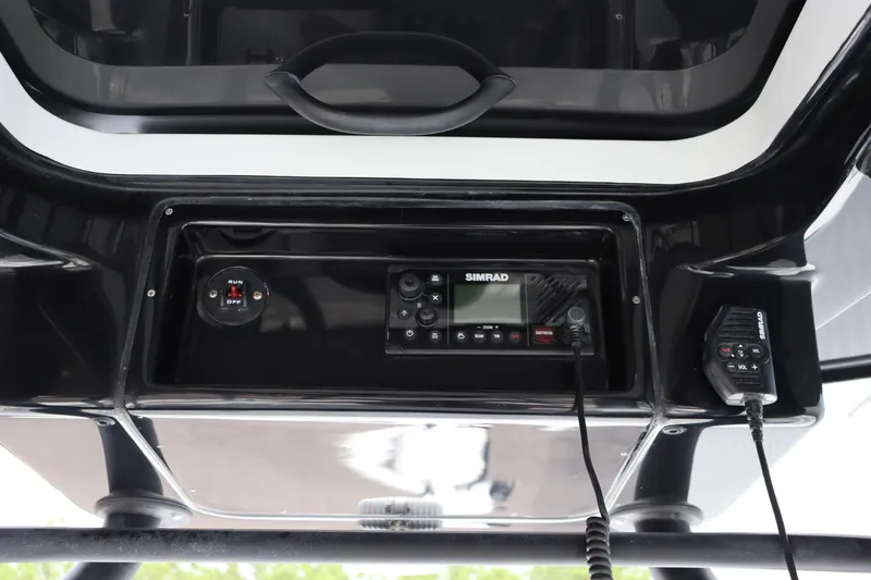 Slide: The Image of 2025 Yellowfin 26 Hybrid boat console with Simrad electronics and communication equipment. - 23