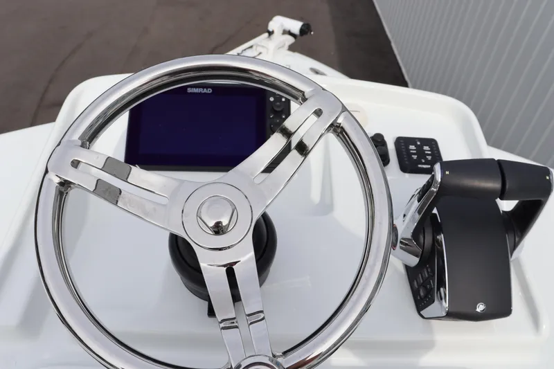 Slide: The Image of Steering wheel and controls of 2025 Yellowfin 26 Hybrid boat. - 27