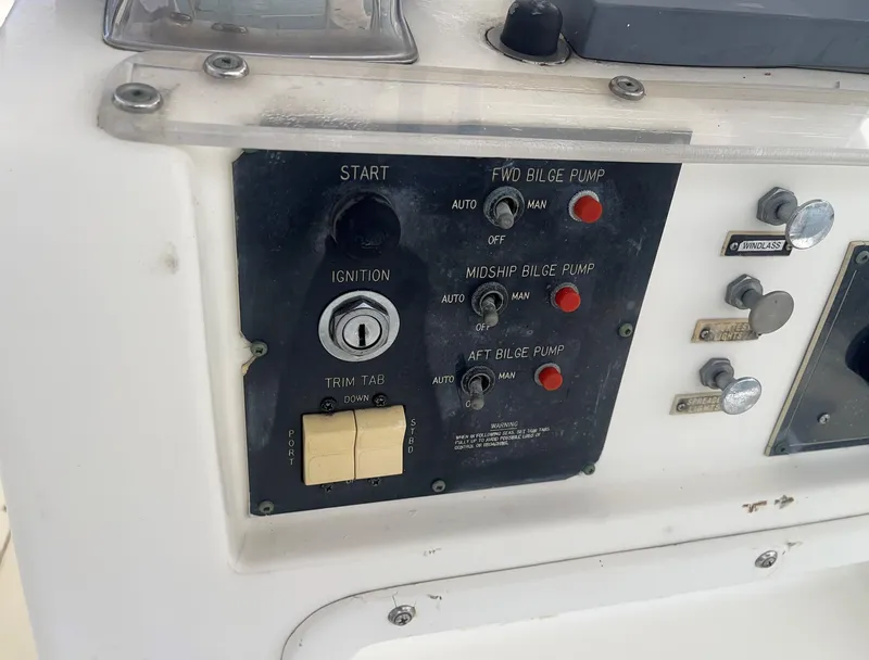 Slide: The Image of Control panel of a 1985 Hatteras 45 Convertible boat with ignition and bilge pump switches. - 22
