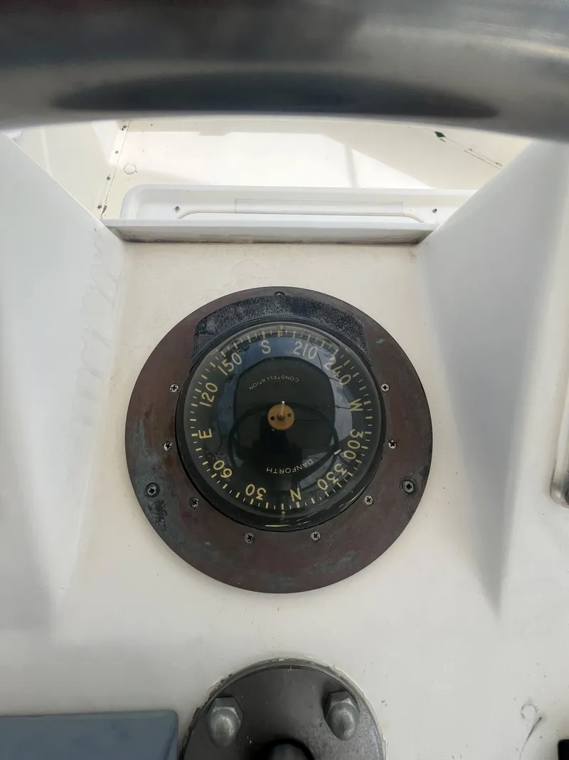 Slide: The Image of Compass on 1985 Hatteras 45 Convertible boat dashboard. - 25