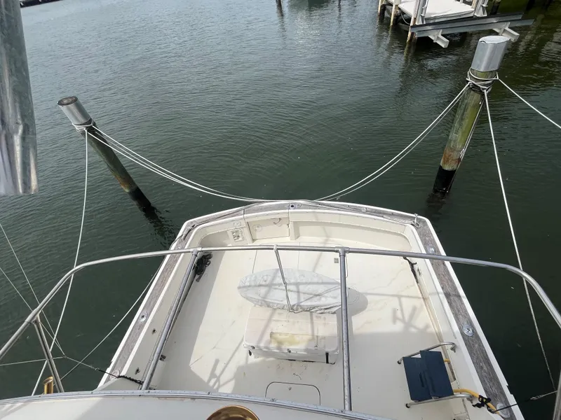 Slide: The Image of 1985 Hatteras 45 Convertible boat docked at marina, view from above. - 30