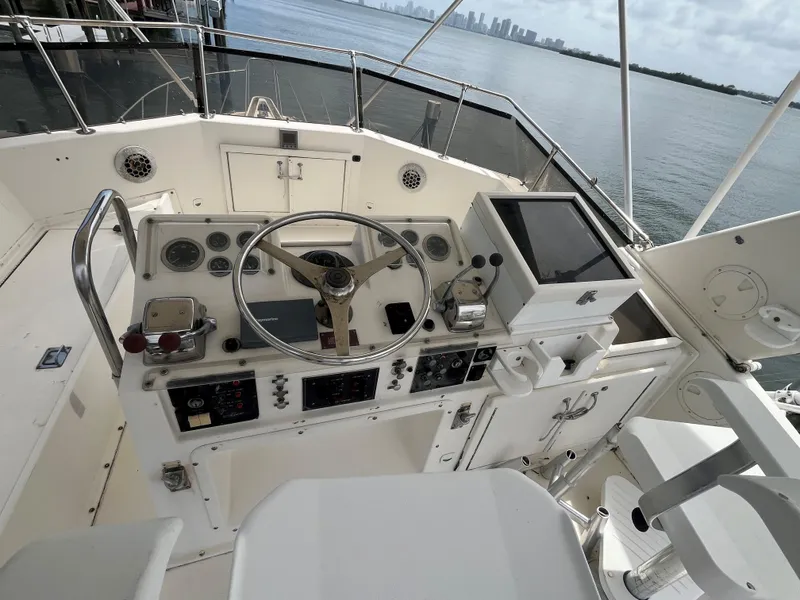 Slide: The Image of 1985 Hatteras 45 Convertible yacht helm with steering wheel and navigation controls. - 34