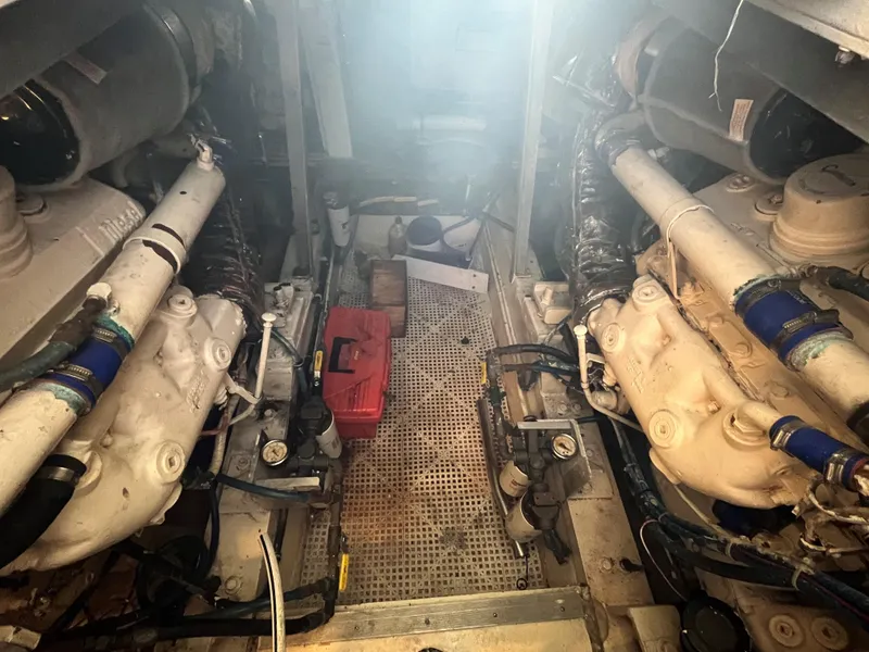 Slide: The Image of Engine room of 1985 Hatteras 45 Convertible boat, showing dual engines and equipment. - 35