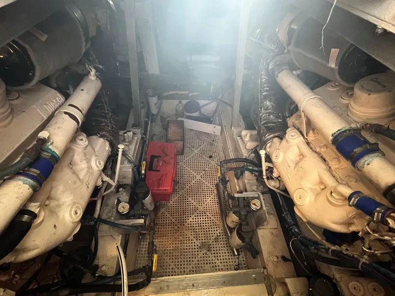 Slide: The Image of Engine room of 1985 Hatteras 45 Convertible yacht, showcasing dual engines and mechanical components. - 40