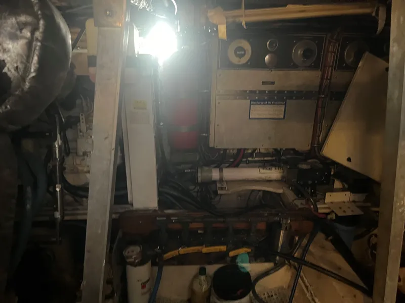 Slide: The Image of Engine room of 1985 Hatteras 45 Convertible boat with mechanical equipment and wiring. - 43