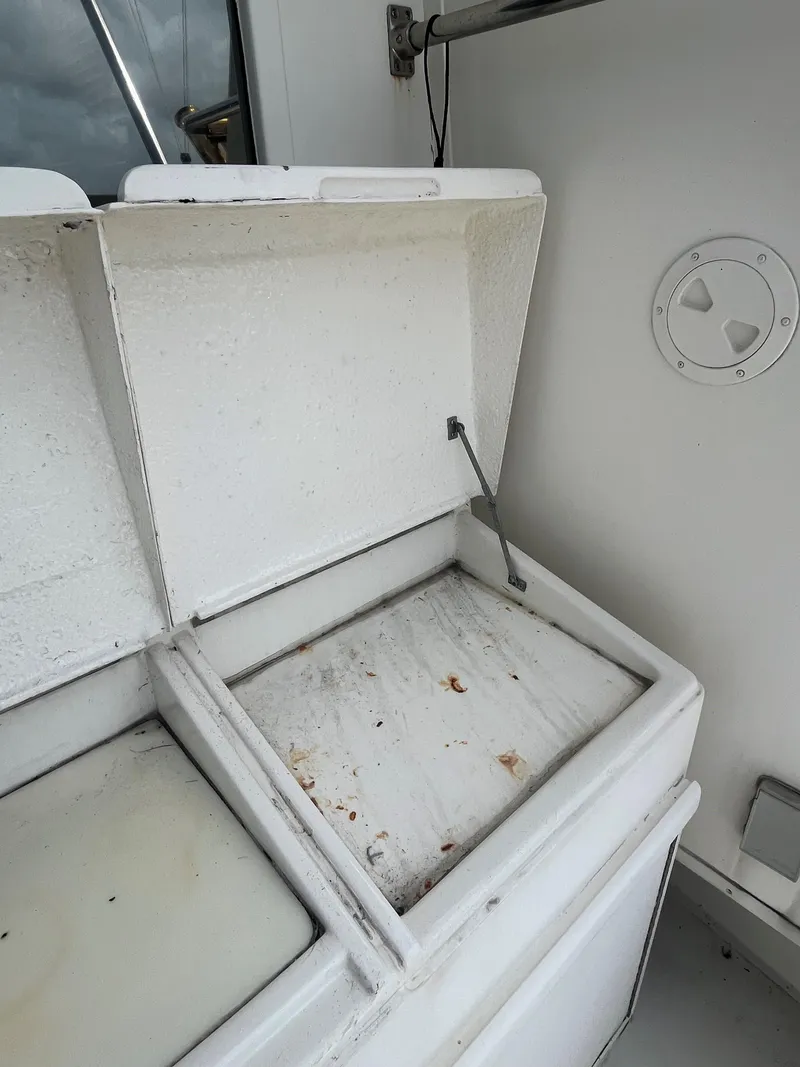 Slide: The Image of Open storage compartment on 1985 Hatteras 45 Convertible boat. - 44