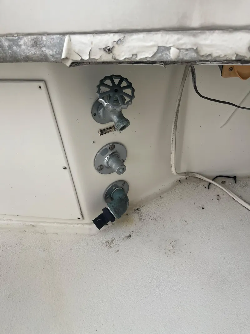 Slide: The Image of 1985 Hatteras 45 Convertible boat interior with control valves and wiring. - 46