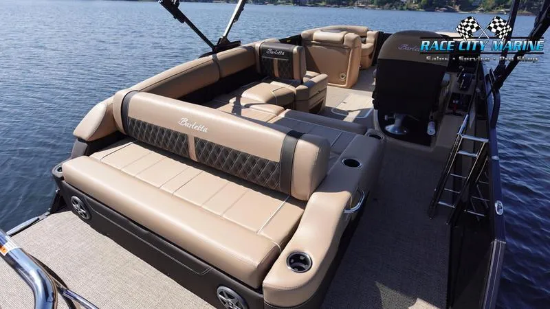 Slide: The Image of 2025 Barletta L23U pontoon boat with luxurious seating on a serene lake. - 12