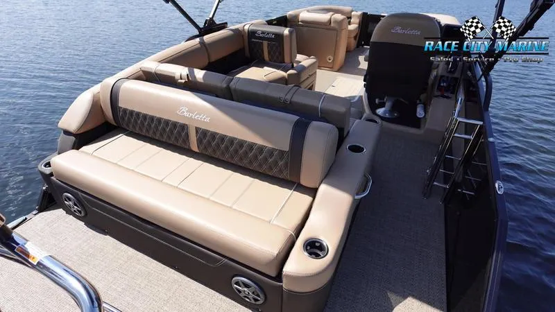 Slide: The Image of 2025 Barletta L23U pontoon boat with luxurious seating on a calm lake. - 13