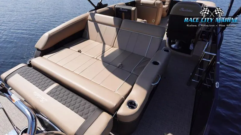Slide: The Image of 2025 Barletta L23U pontoon boat with luxurious seating on calm water. - 14