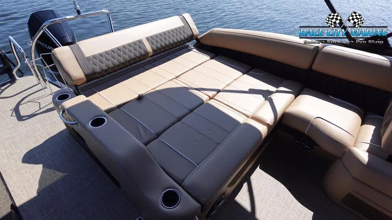 Slide: The Image of 2025 Barletta L23U boat interior with spacious seating and cup holders on a sunny day. - 16