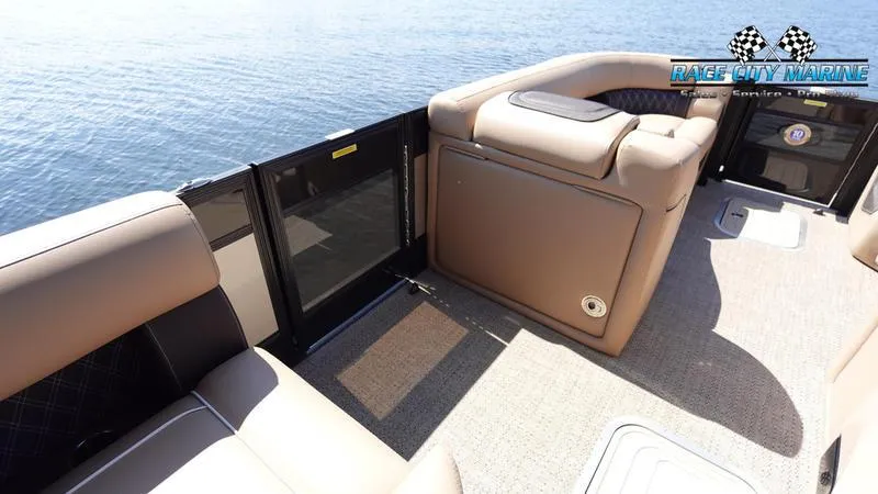 Slide: The Image of 2025 Barletta L23U pontoon boat interior with tan seating and lake view. - 24