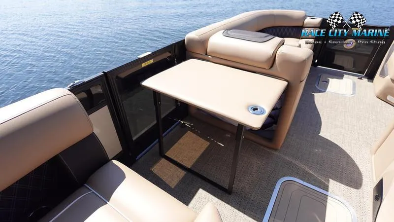Slide: The Image of 2025 Barletta L23U pontoon boat interior with seating and table on the water. - 25