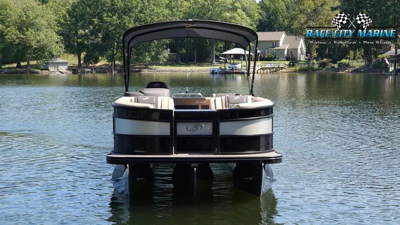 Slide: The Image of 2025 Barletta L23U pontoon boat on a serene lake with lush greenery. - 3