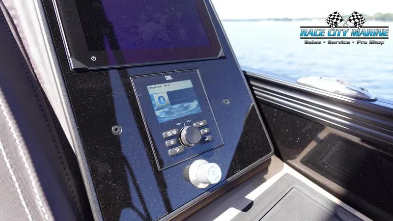 Slide: The Image of 2025 Barletta L23U boat dashboard with JBL audio system, Race City Marine logo. - 31
