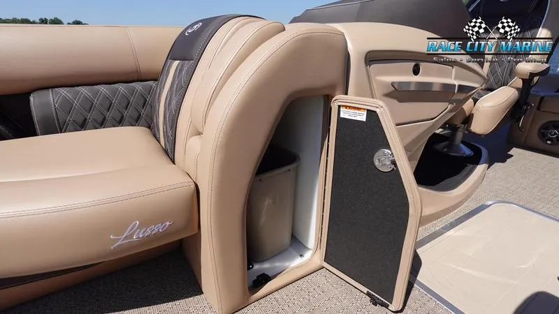Slide: The Image of 2025 Barletta L23U boat interior with open storage compartment, luxurious seating, and Race City Marine logo. - 40