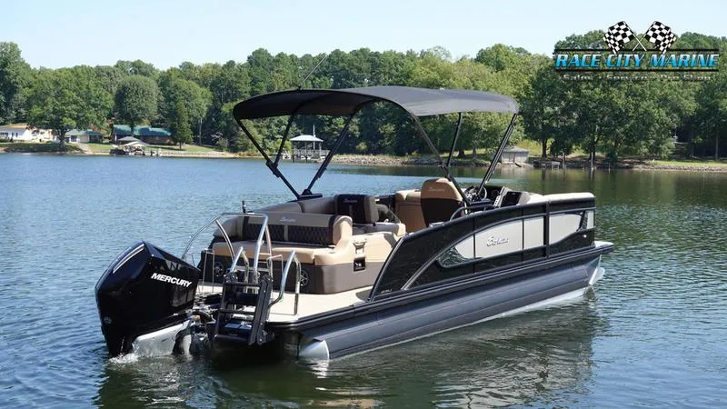 Slide: The Image of 2025 Barletta L23U pontoon boat on a lake with lush green trees. - 8