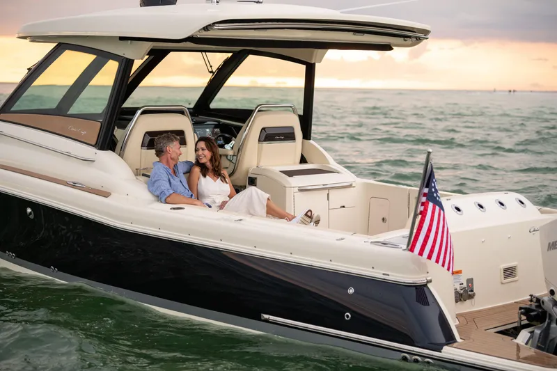 Slide: The Image of 2026 Chris-Craft Calypso 35 helm with wooden steering wheel and modern controls. - 13