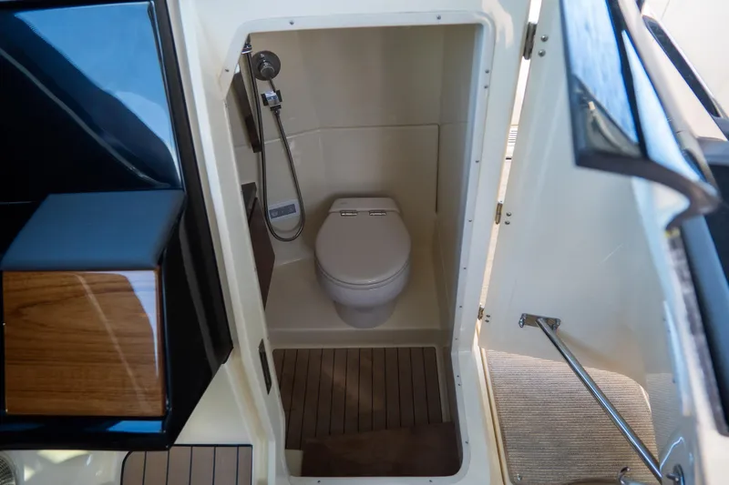 Slide: The Image of 2026 Chris-Craft Calypso 35 boat bathroom with modern toilet and wooden flooring. - 21