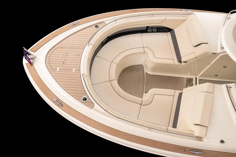 Slide: The Image of Spacious deck of 2026 Chris-Craft Calypso 35 with beige seating and storage compartments. - 3