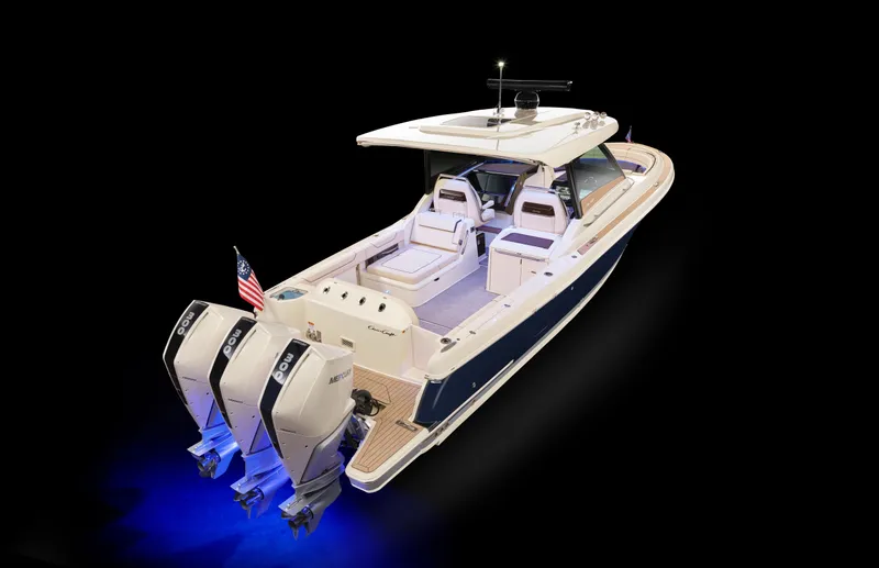 Slide: The Image of 2025 Chris-Craft Calypso 35 boat with dual engines and sleek design, illuminated in blue. - 38